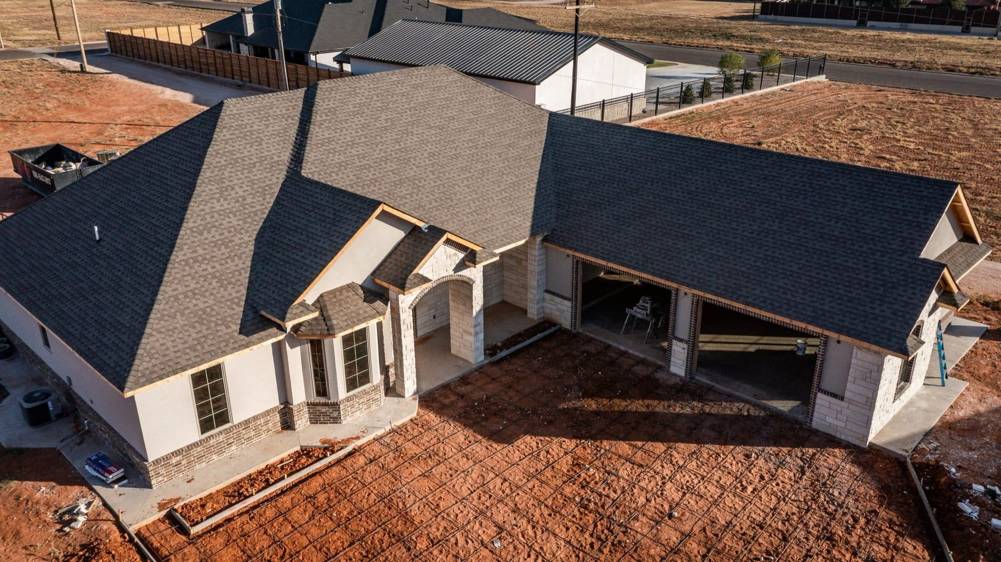 Aerial view showing the rooflines of a completed home exterior