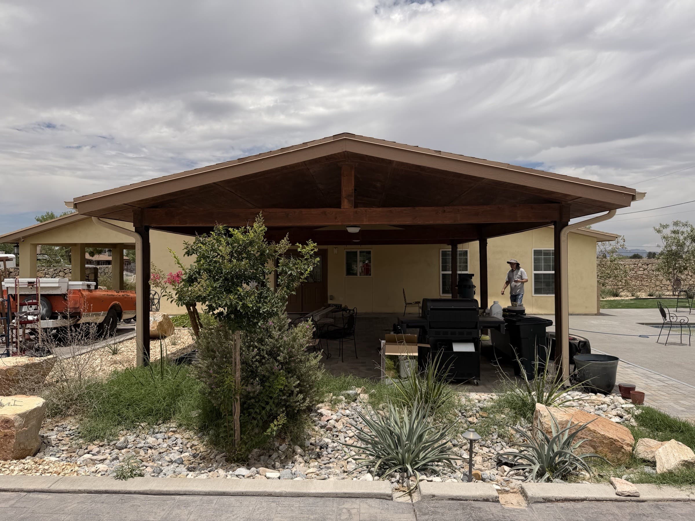 Covered patio with a finished gutter and downspout