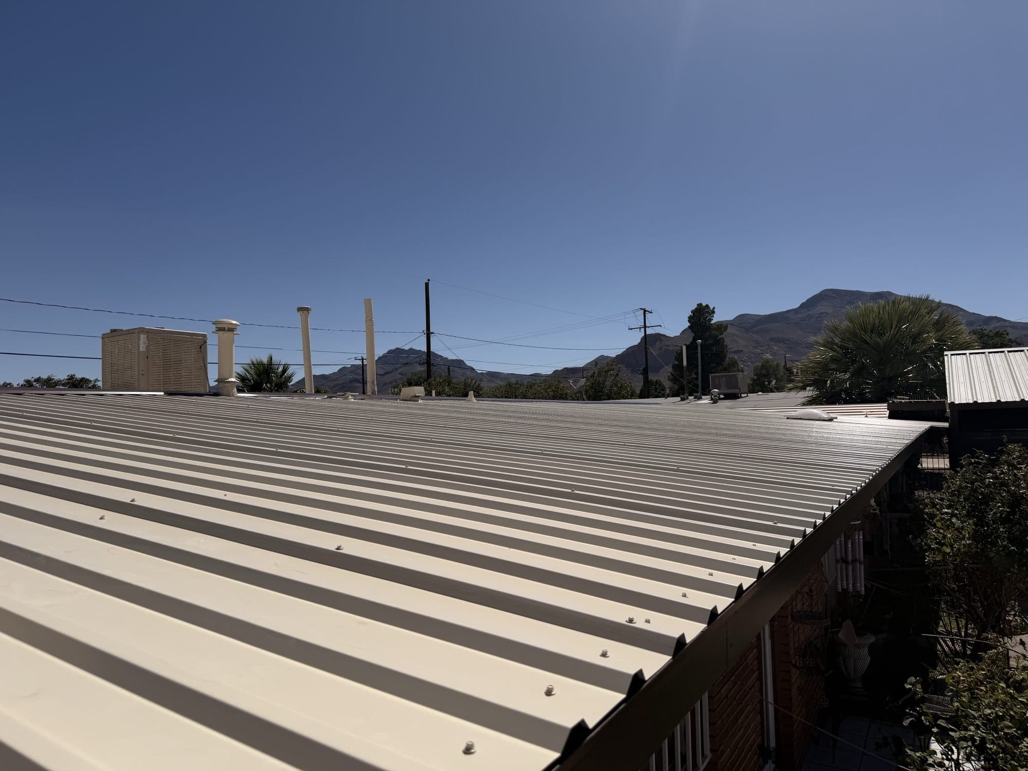 Wide view of a completed ribbed metal roof