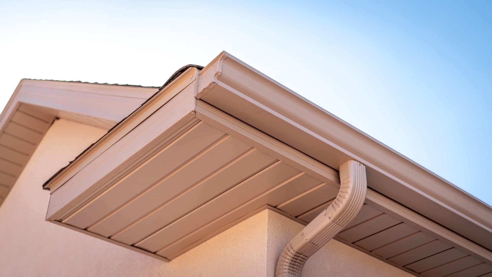 Finished gutter, fascia, and soffit meeting at a roof corner